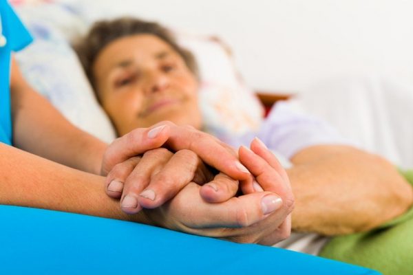 Caring Nurse Holding Hands